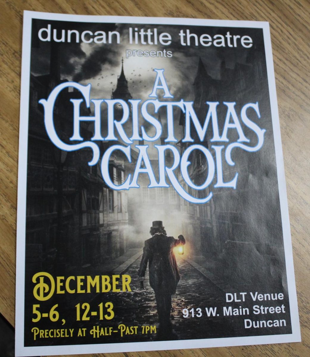 A poster for "A Christmas Carol" sits on a desk at Duncan Middle School.