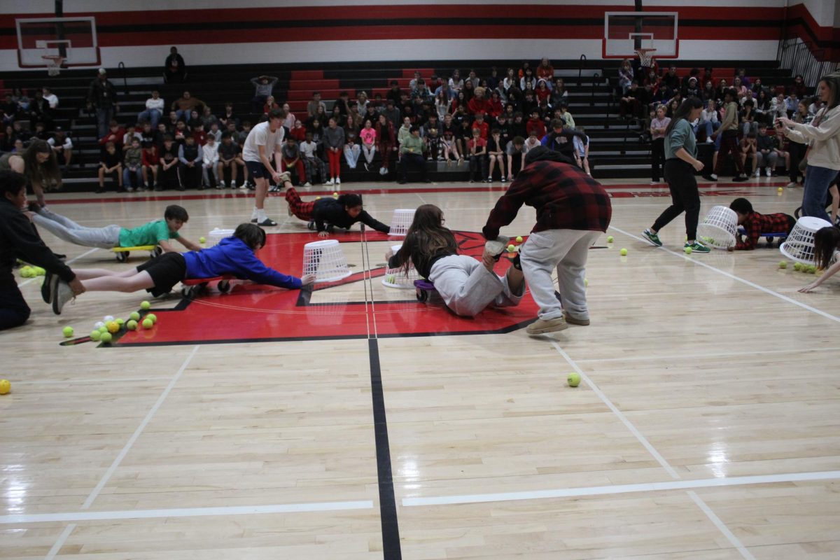 Students play a game of Hungry, Hungry Hippos.