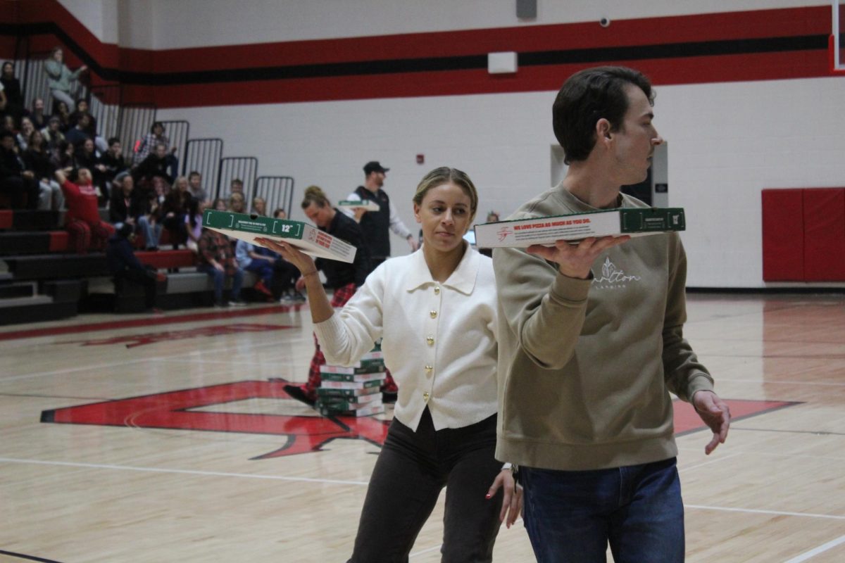 Deven Speed goes after Reavis Hammond's pizza box.