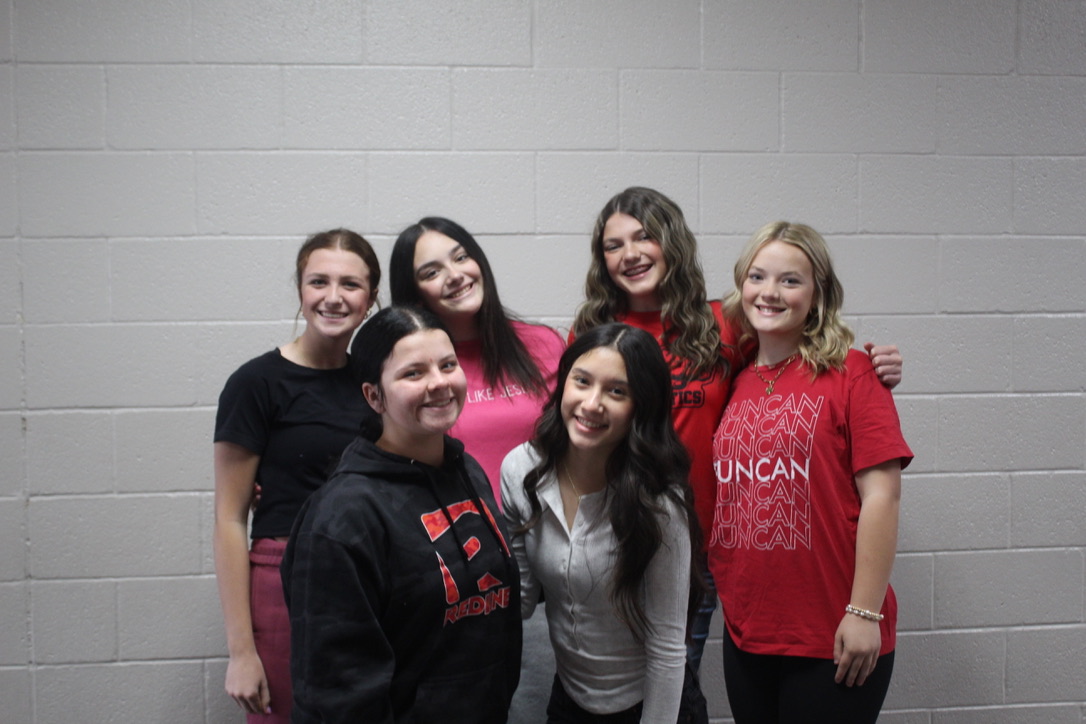 A group of Duncan Middle School cheerleaders gather for a photo. High school cheer tryouts are underway.