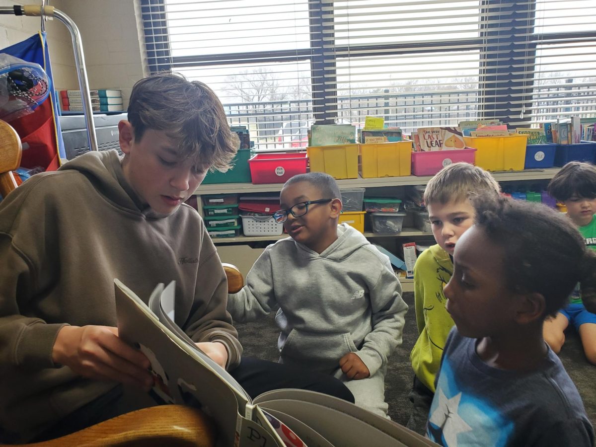 Parker Sanders reads to students at Mark Twain Elementary during Read Across America on Wednesday.