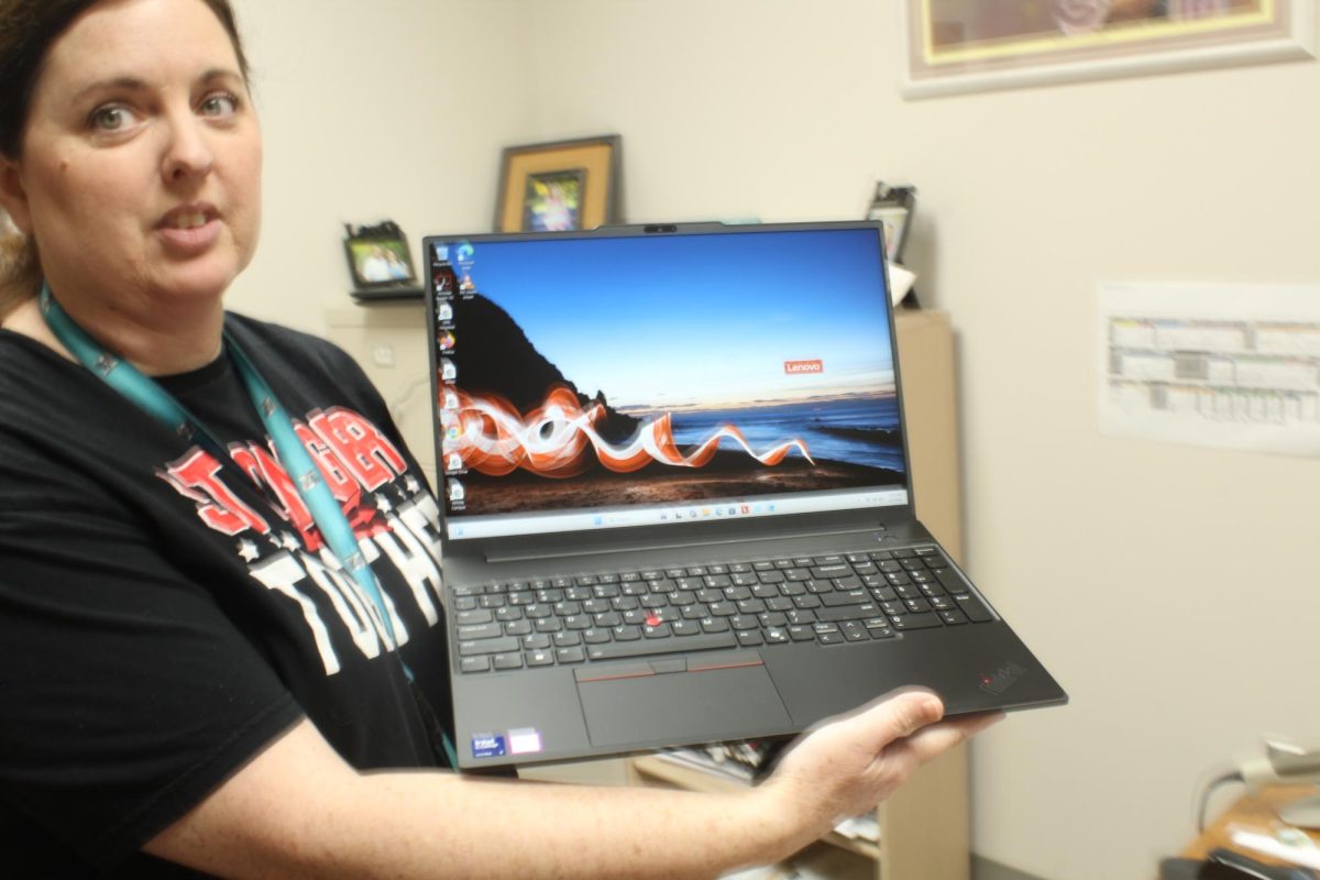 DMS librarian Barbara Gee shows off one of the new teacher computers. The laptop rollout took place on the most recent virtual day.