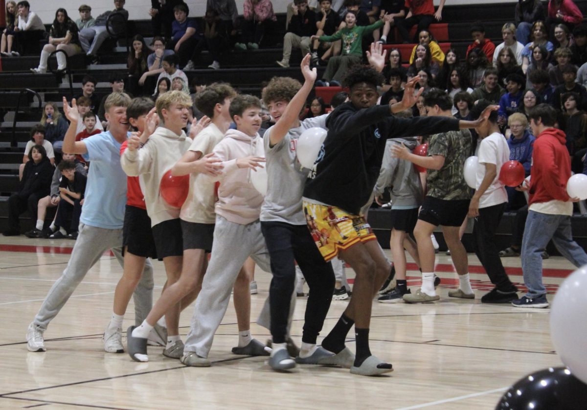 Basketball players compete in a game during the winter pep rally.